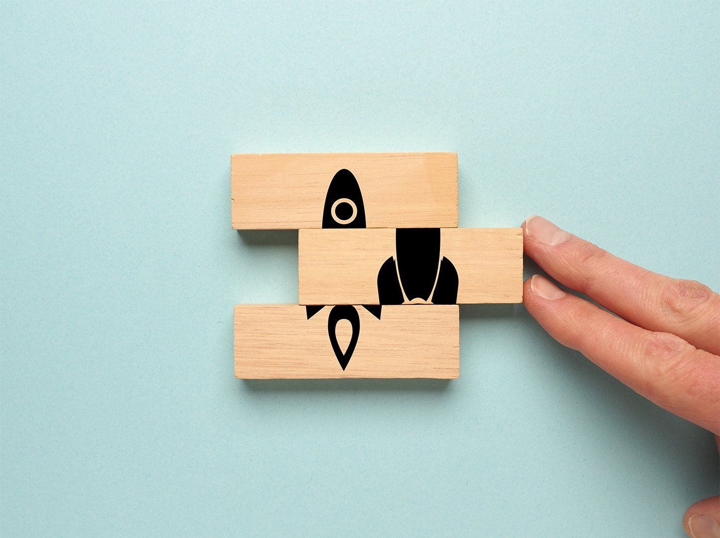 start up concept with rocket on wooden blocks