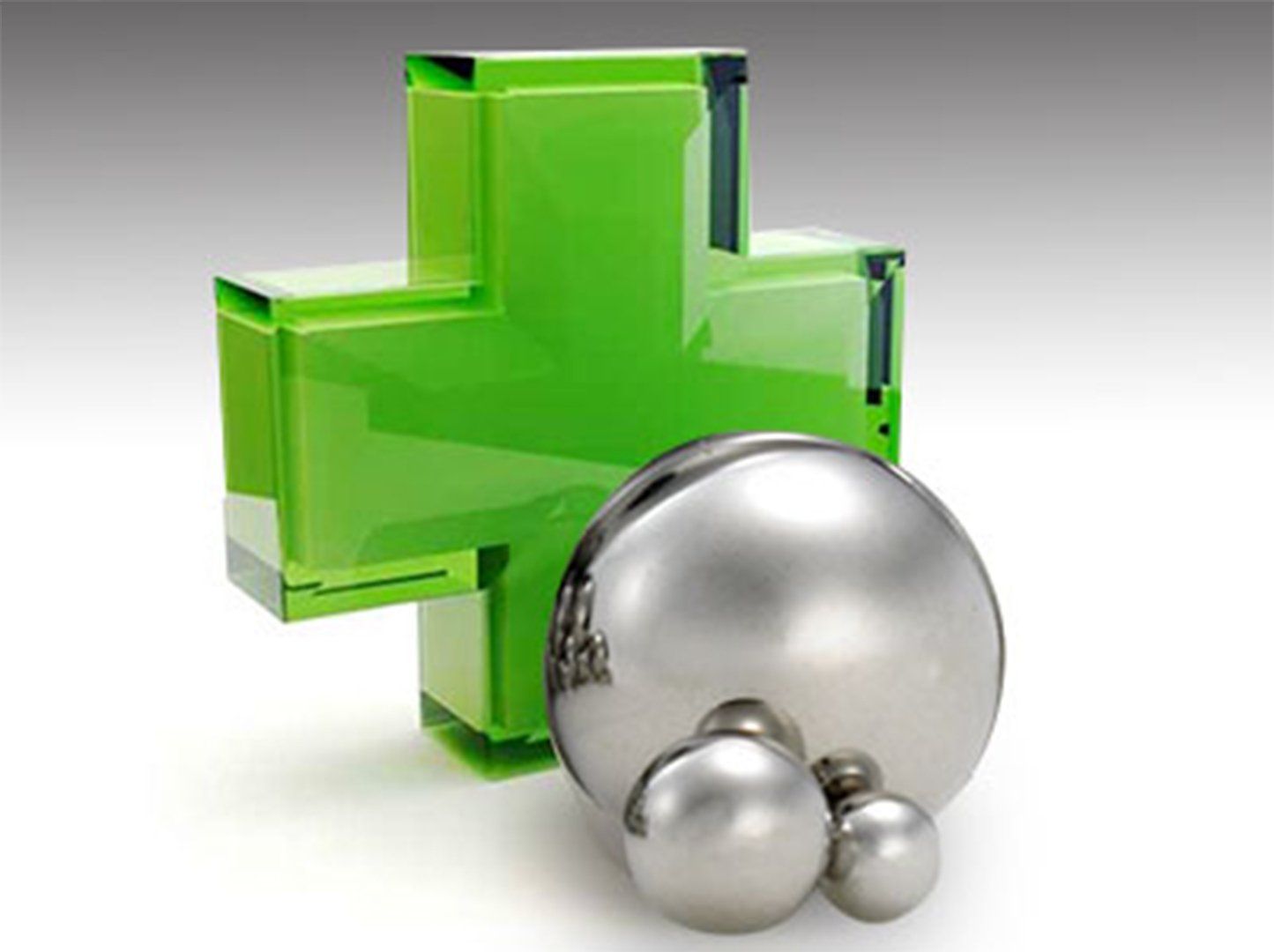 green cross with metal balls in front