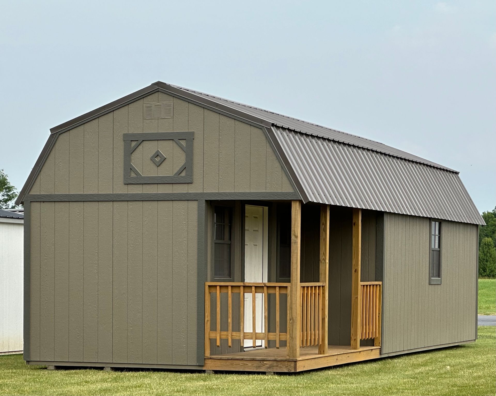 A barn shed with a porch and a window