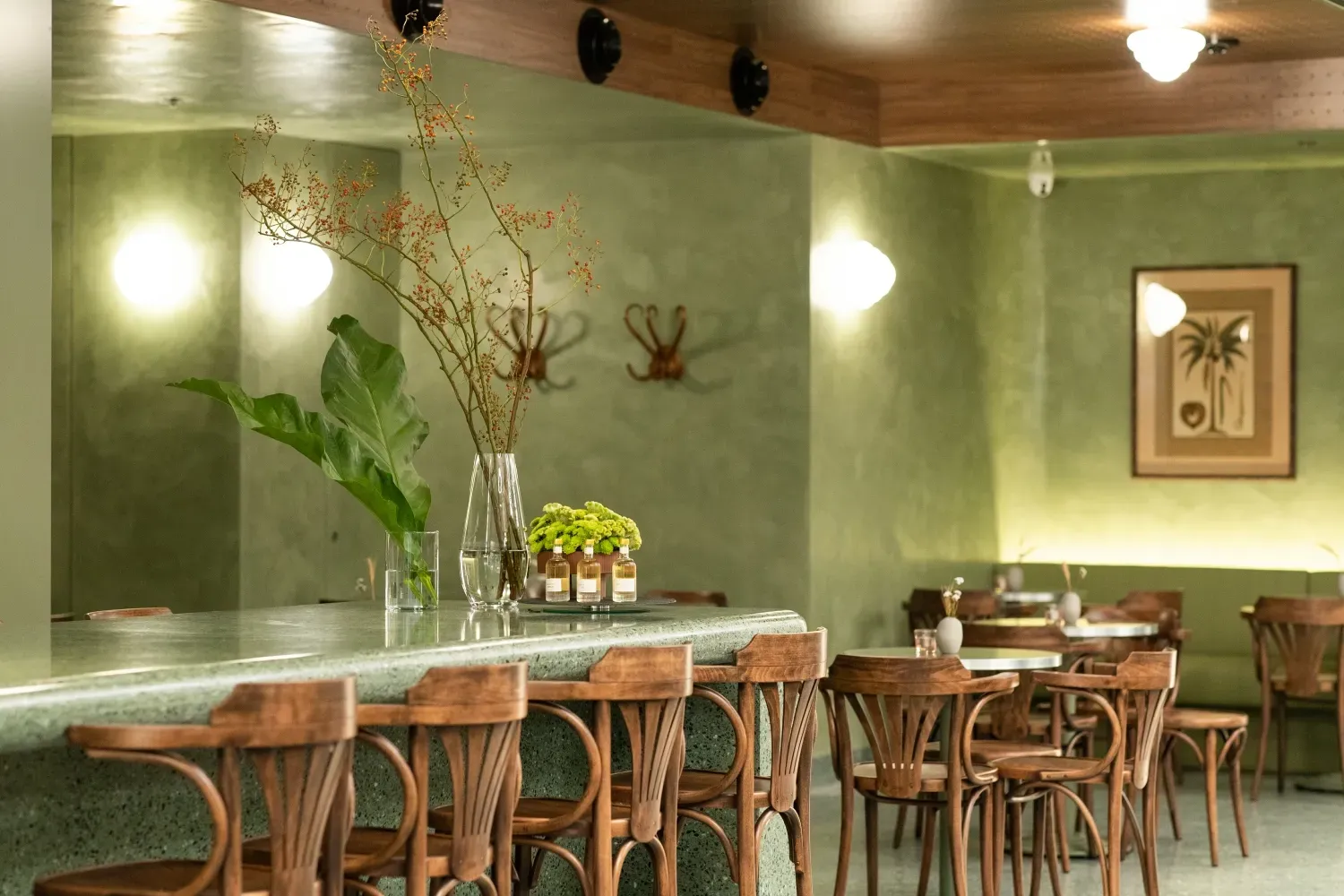 A restaurant with tables and chairs and a bar.