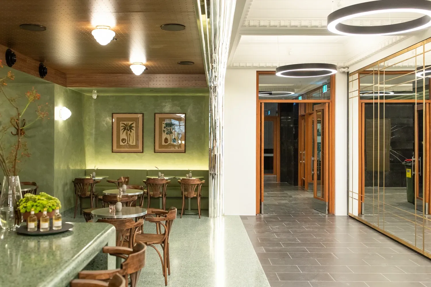 A restaurant with tables and chairs and a bar.