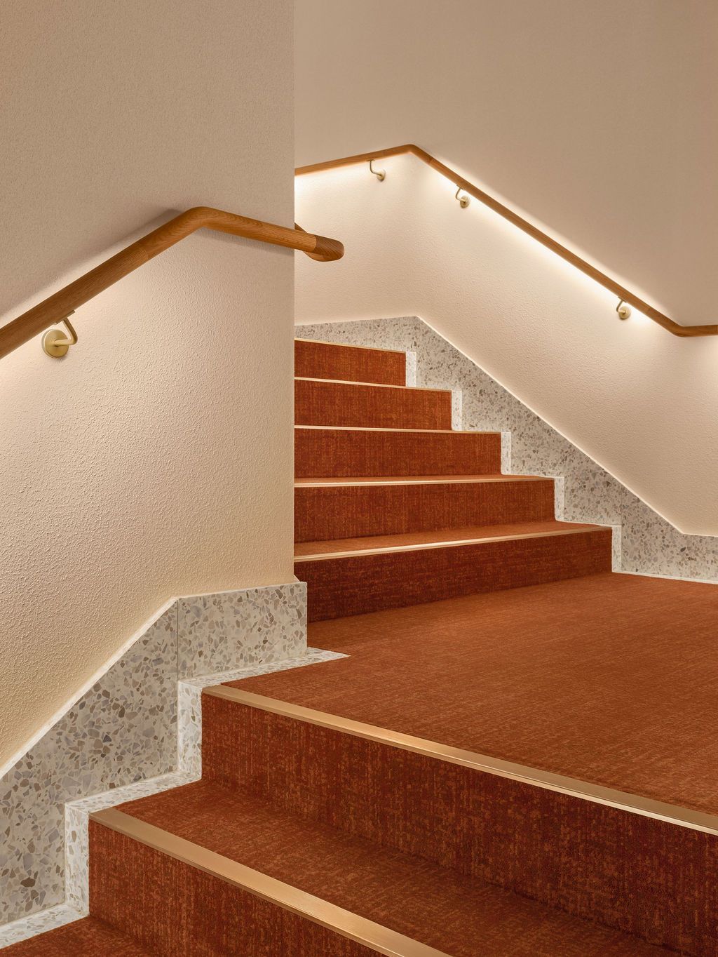 A hallway with a lamp hanging from the ceiling