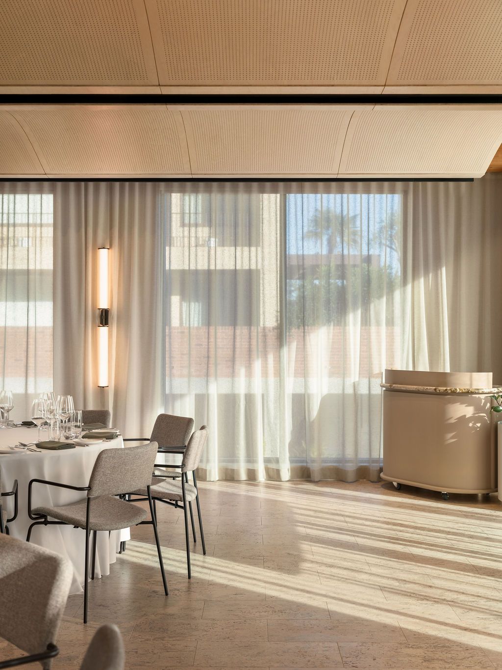 A hallway with a painting on the wall and a lamp hanging from the ceiling.