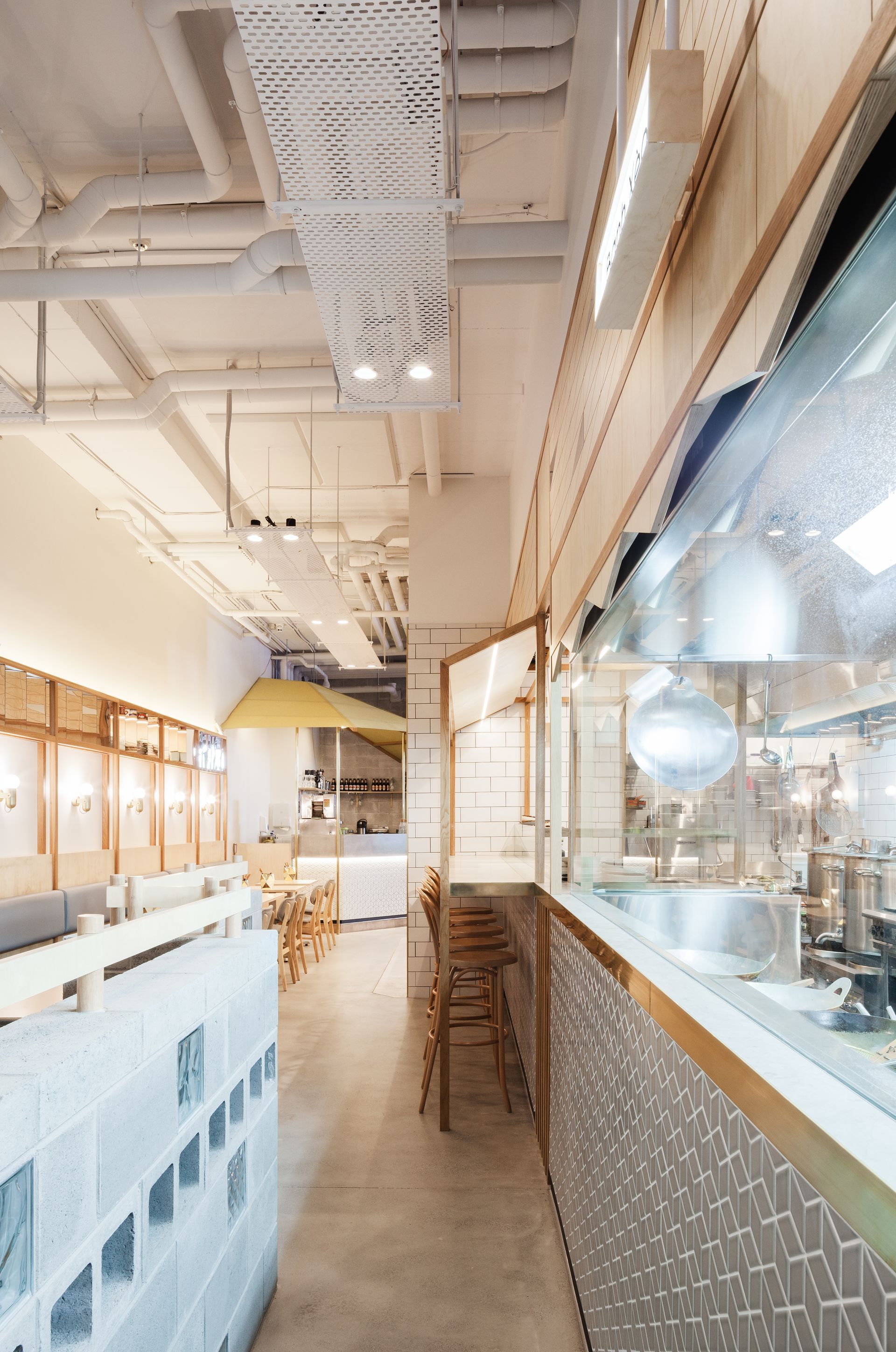 A long hallway leading to a kitchen in a restaurant.