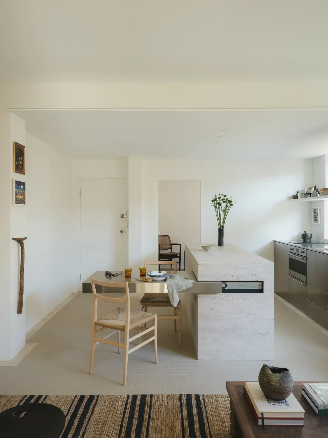 A living room with a table and chairs in it