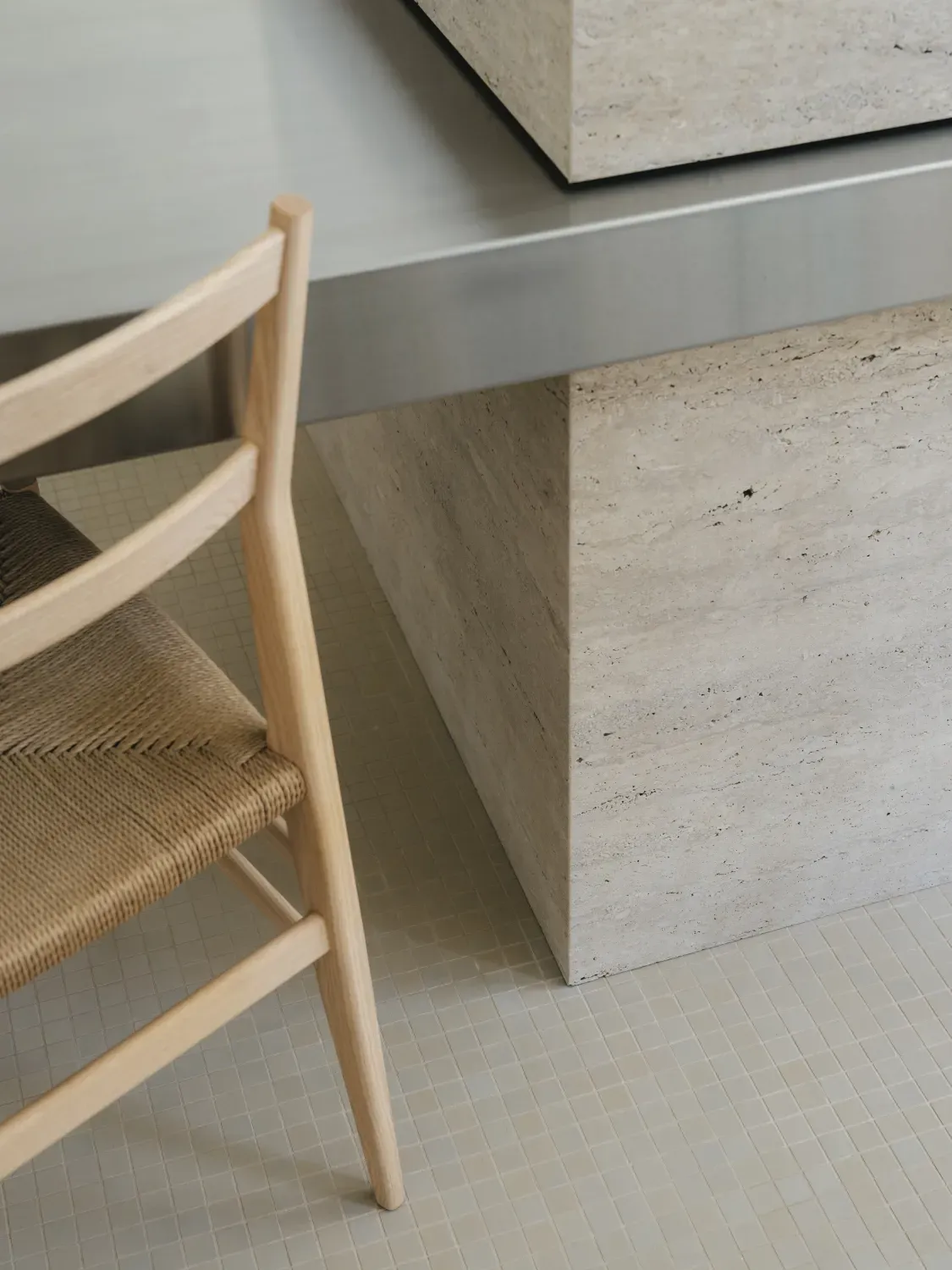 A wooden chair is sitting next to a stone table