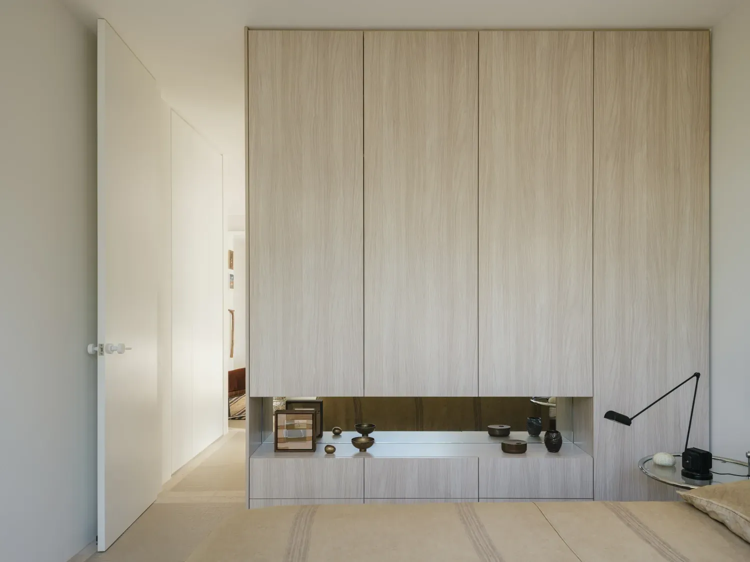 A bedroom with a bed and a mirror on the wall