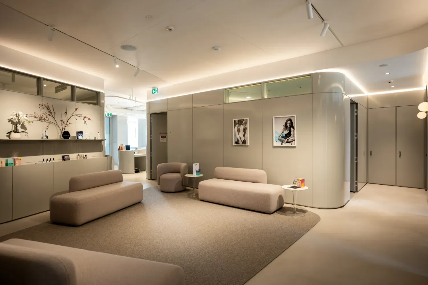 A waiting room with a couch , chairs , and a table.