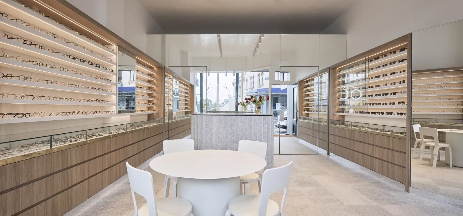 There is a table and chairs in the middle of the room.