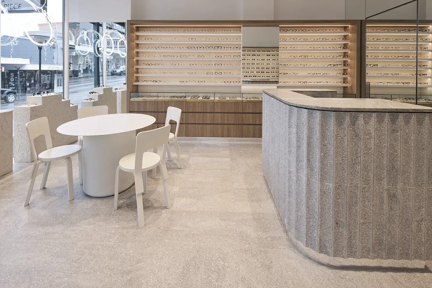 There is a table and chairs in the middle of the room.