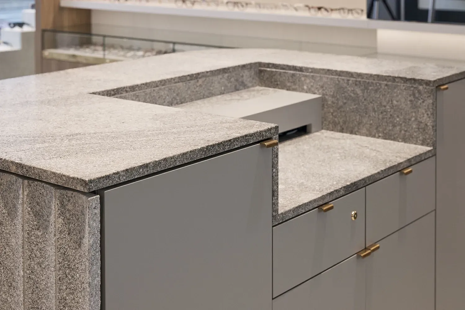 A kitchen with a granite counter top and a sink.