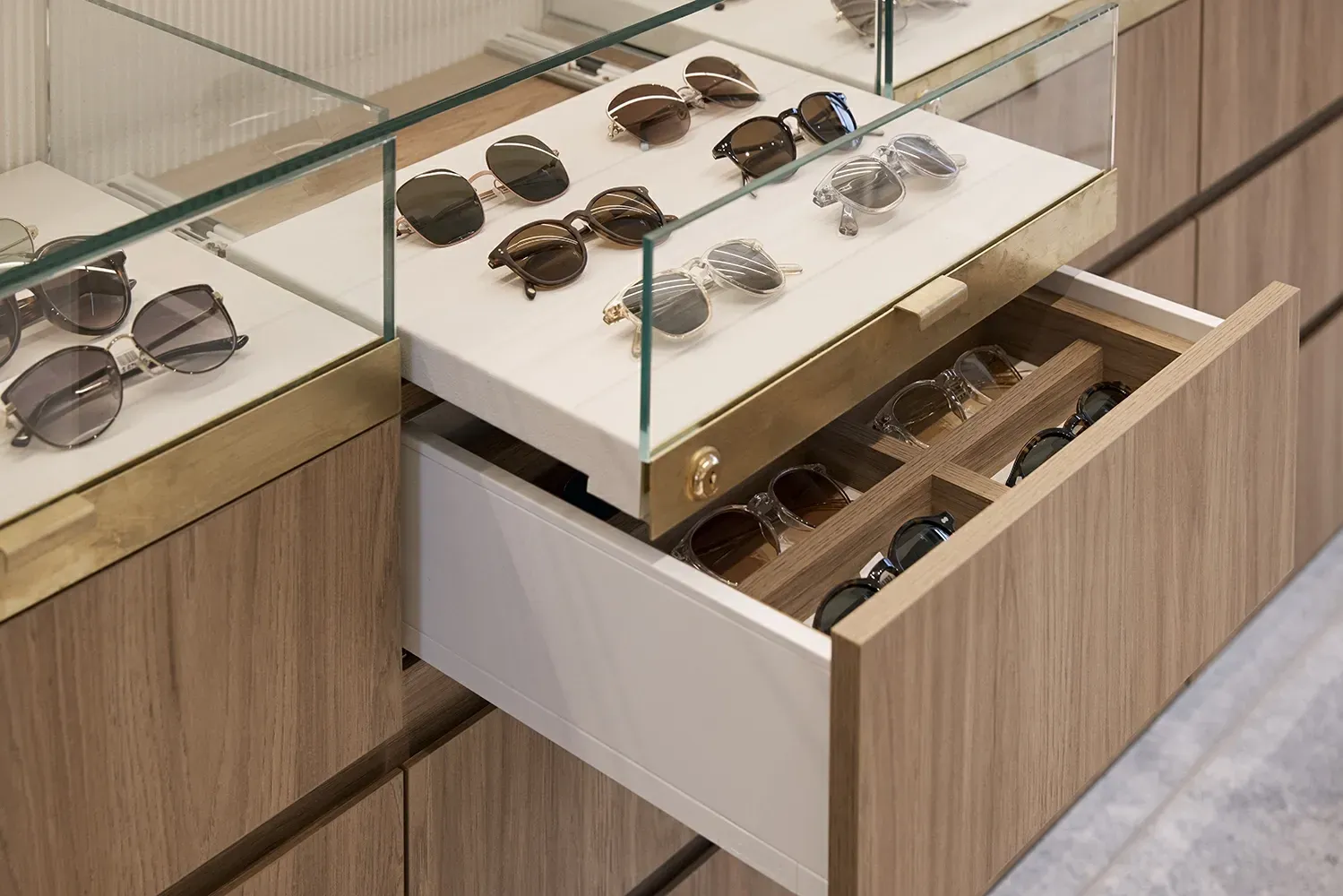 A drawer filled with sunglasses in a store.