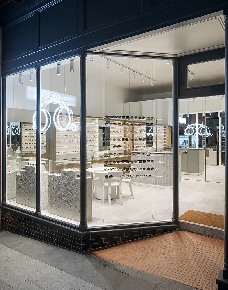 An artist 's impression of an optical shop with a large window.