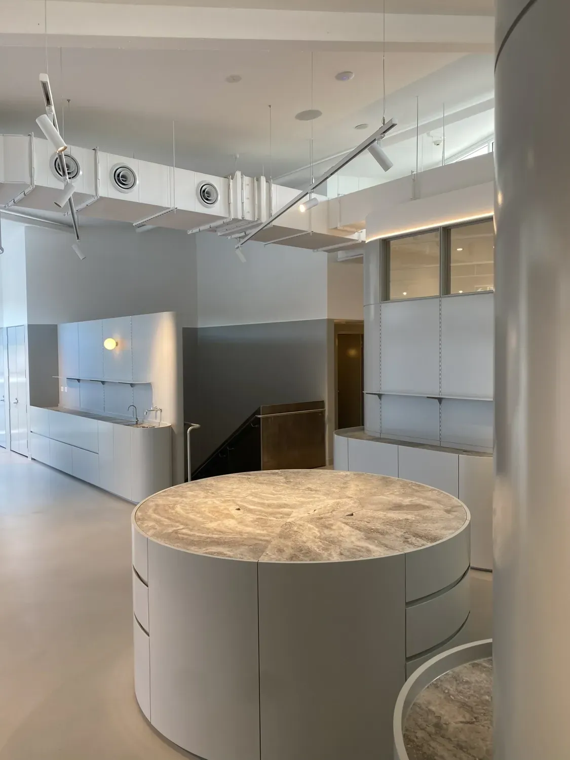 There is a large round table in the middle of the room.