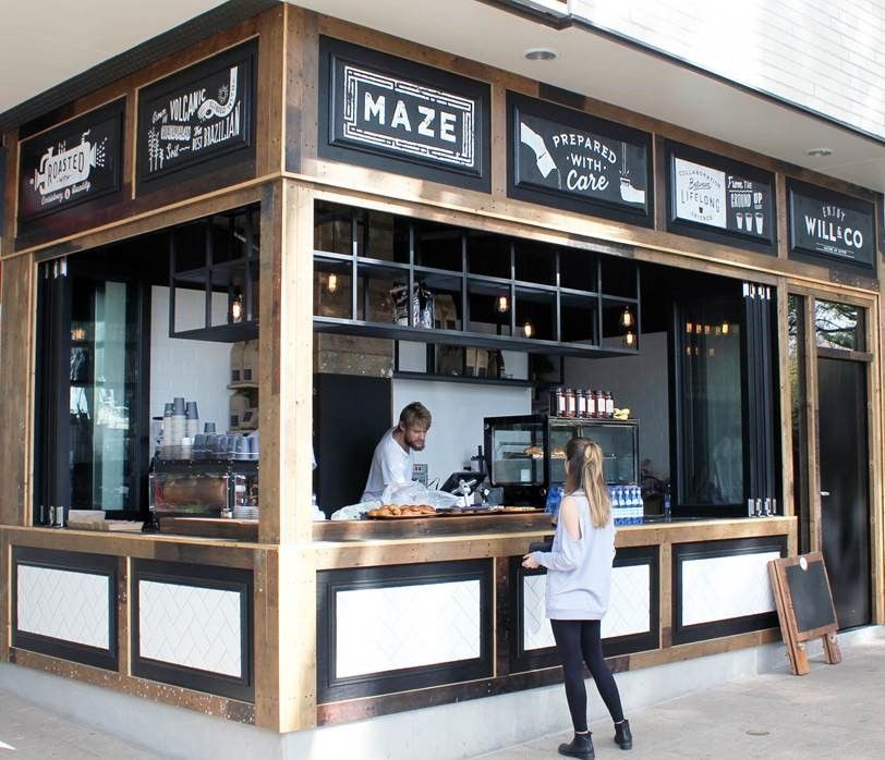 A woman is standing in front of a restaurant called maze