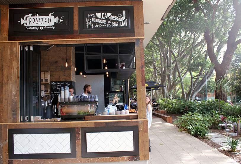 A kiosk with a sign that says roasted on it