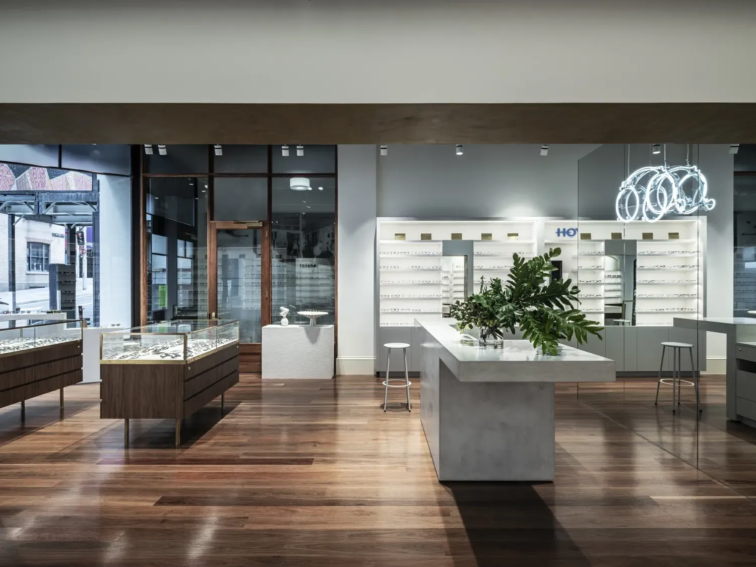 A jewelry store with a wooden floor and a table in the middle of the room.