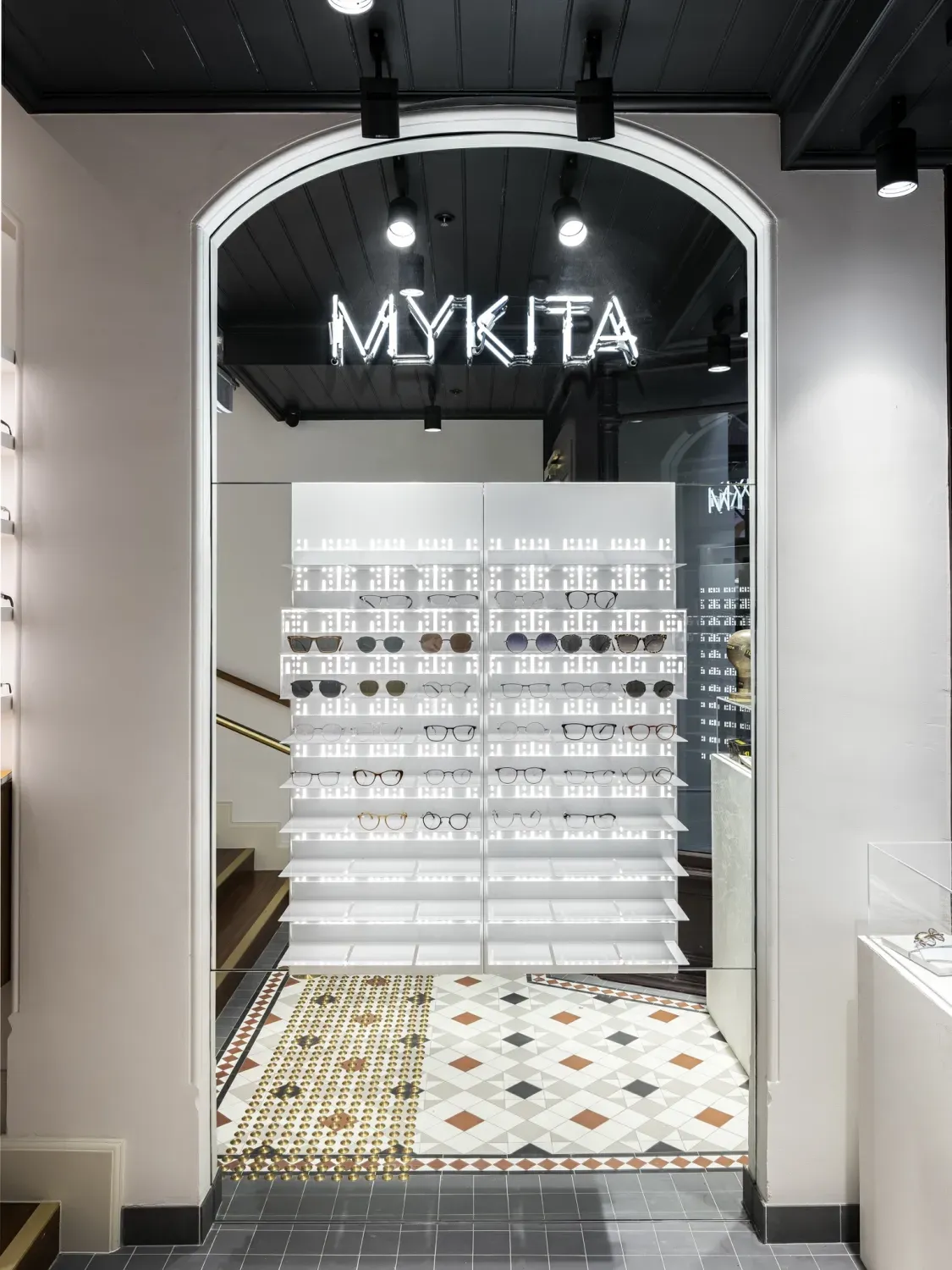 A store with a glass door and a sign that says mykita.