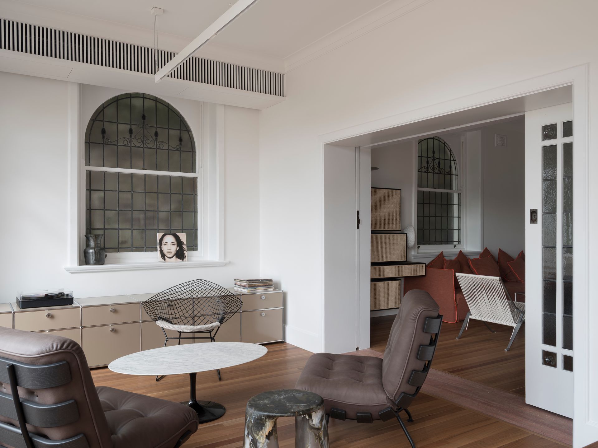 A living room with chairs a table and a window