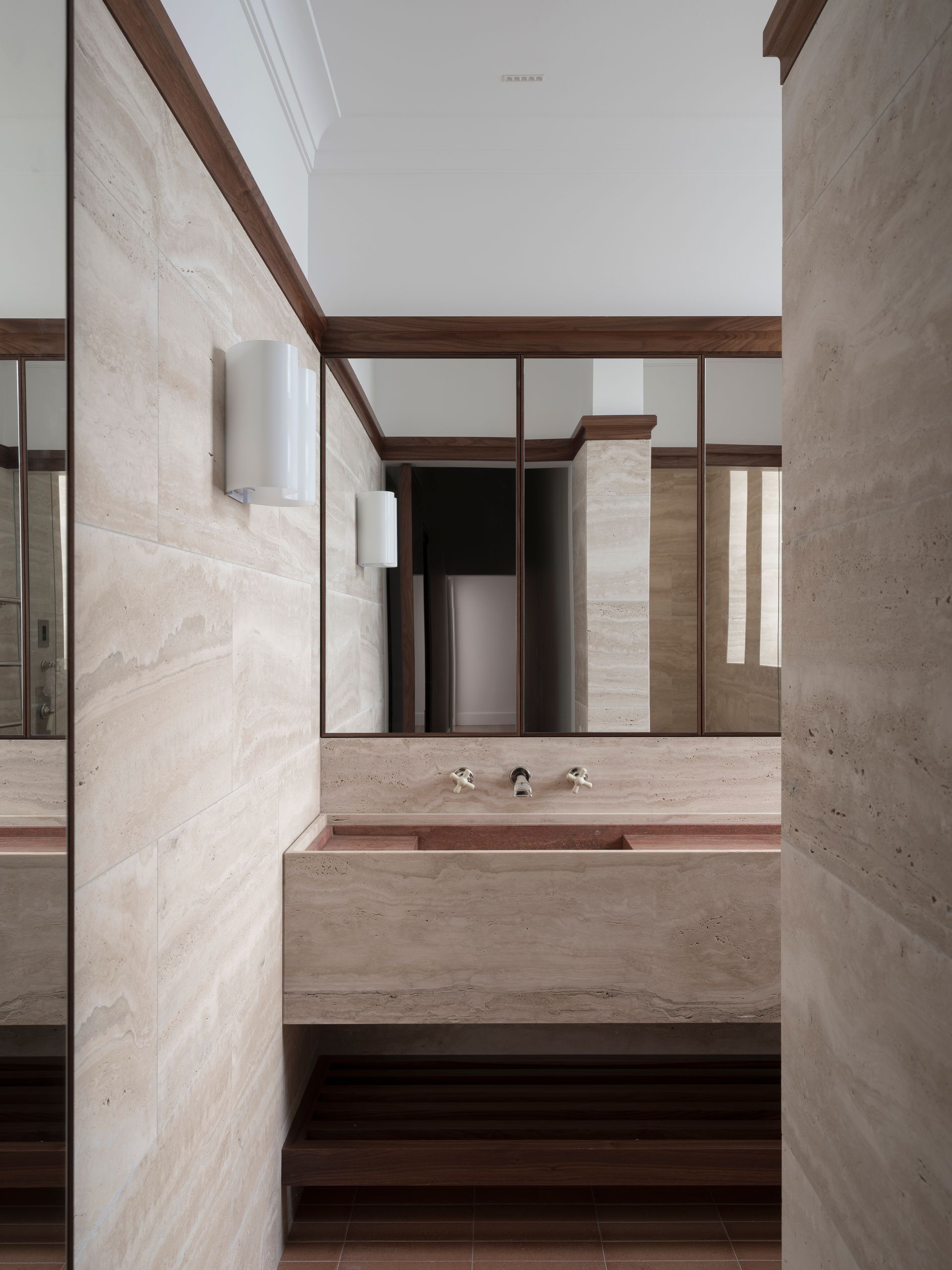 A bathroom with a sink and a large mirror