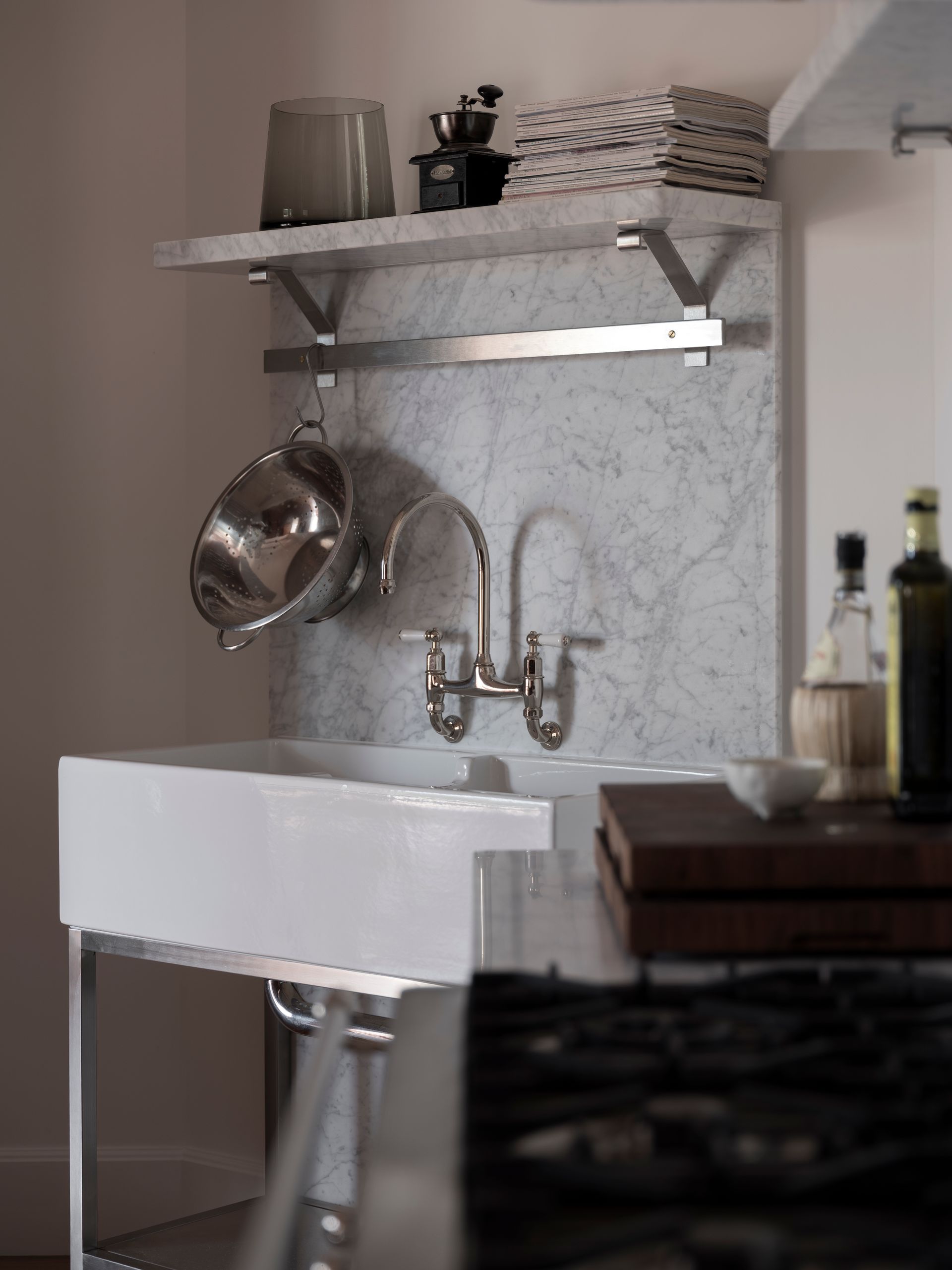 A kitchen sink with pots and pans hanging from it