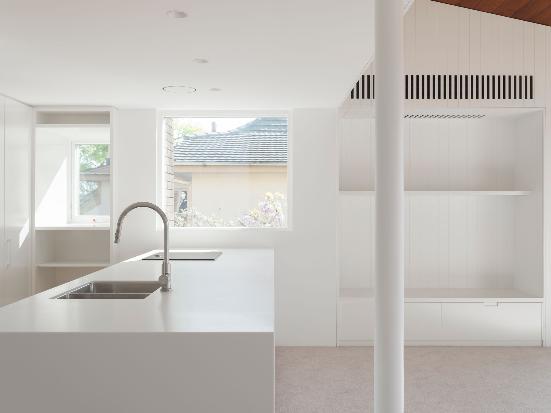 A kitchen with two sinks and a window.
