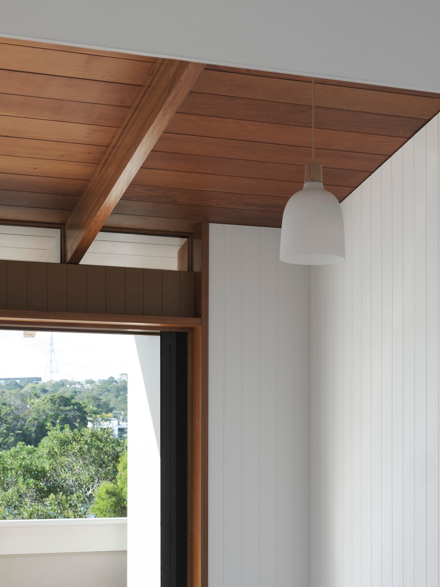A room with a wooden ceiling and white walls