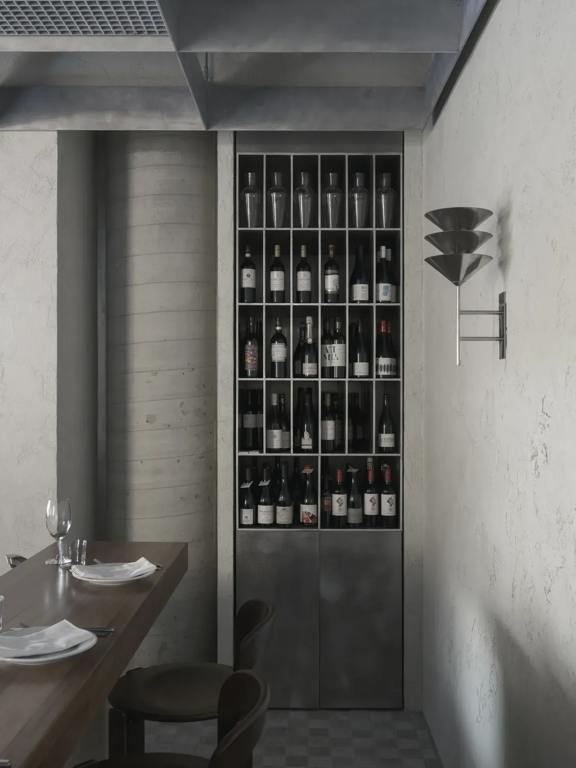 A room with a shelf full of wine bottles