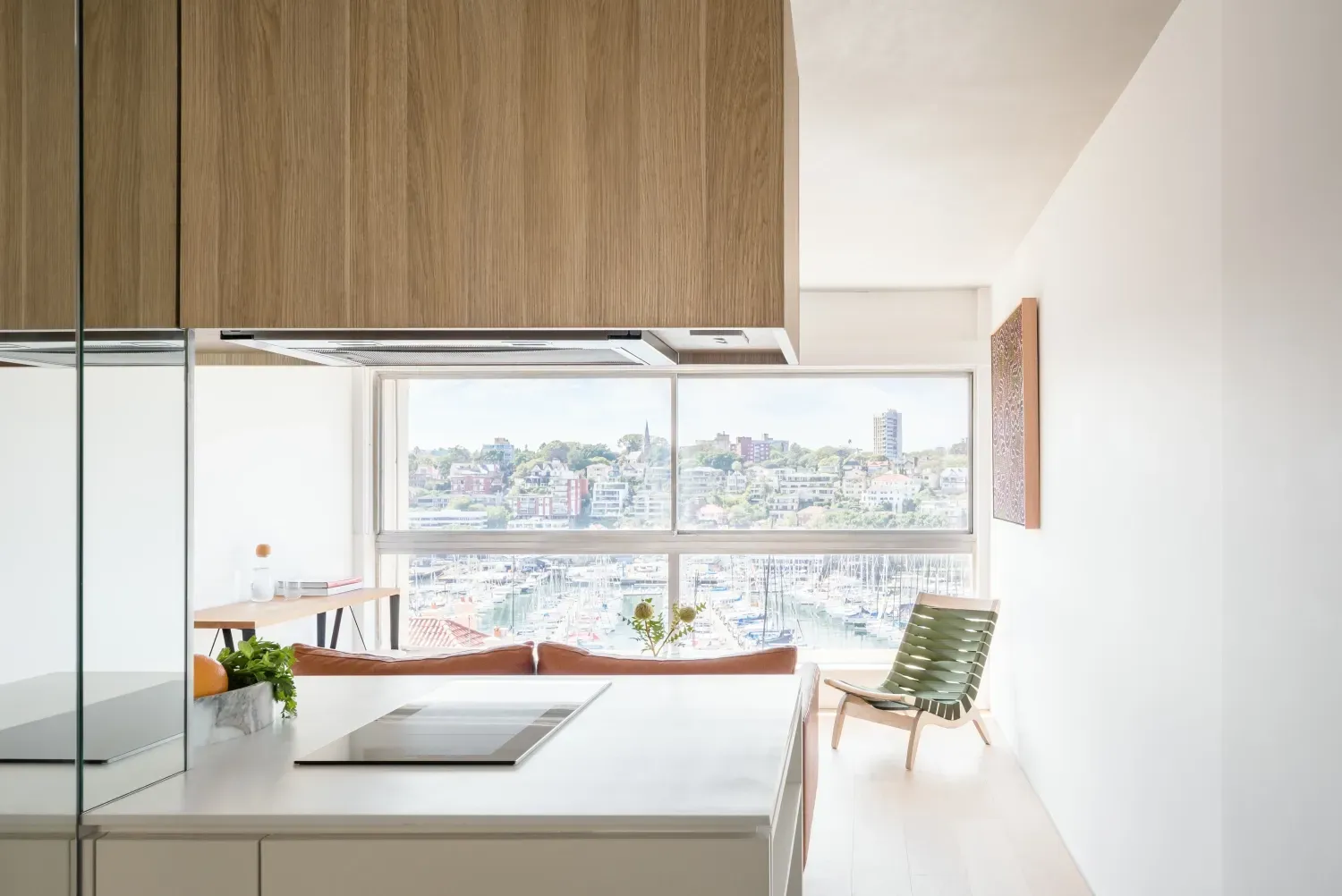 A kitchen with a stove top oven and a large window.