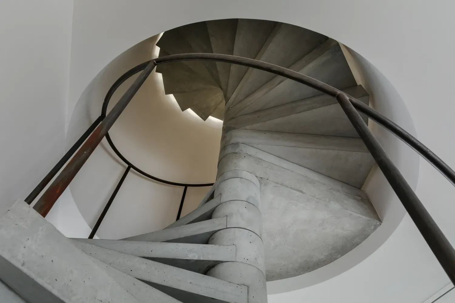 Looking up at a spiral staircase in a building