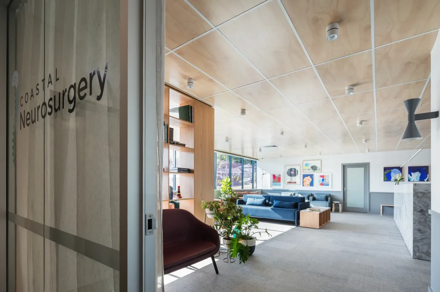 A room with a couch and chairs in it and a sign that says ' neurosurgery ' on it.