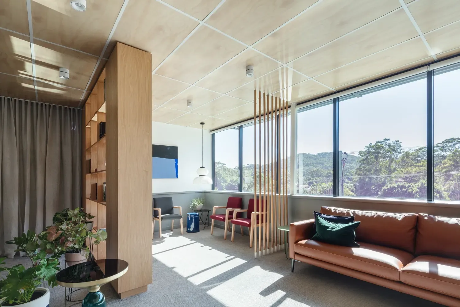 A living room with a couch , chairs and a table.