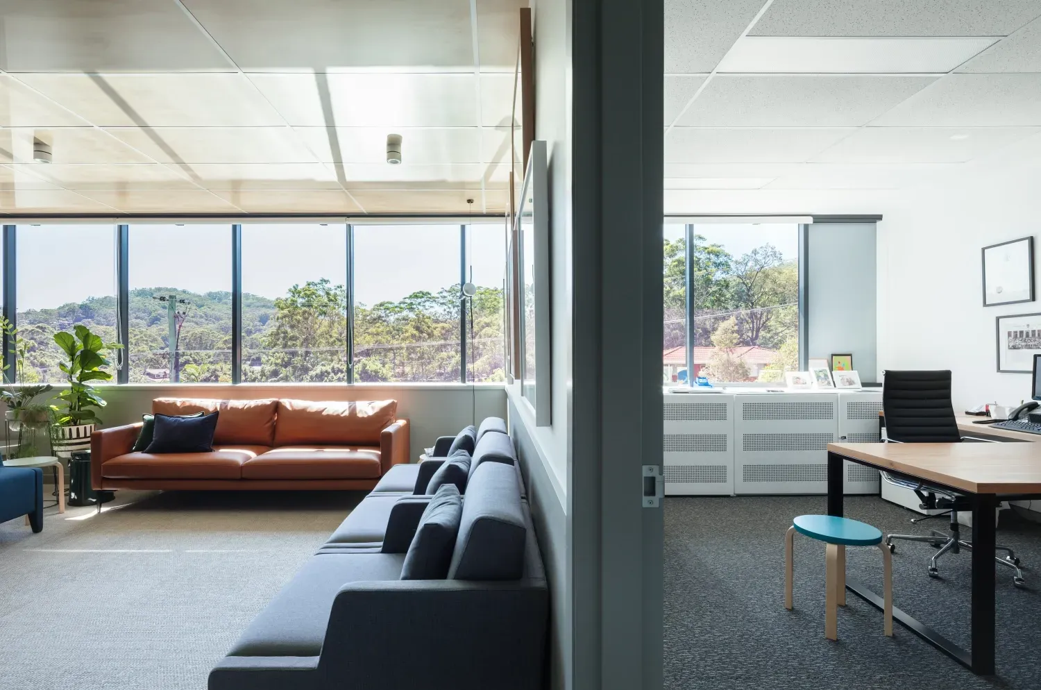 A living room with a couch and a desk in it