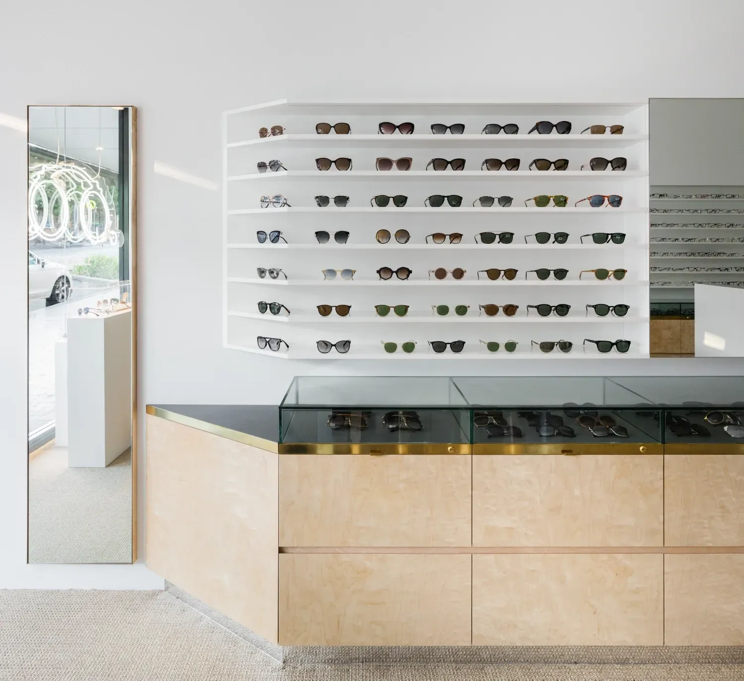 A display of sunglasses and a mirror in a store
