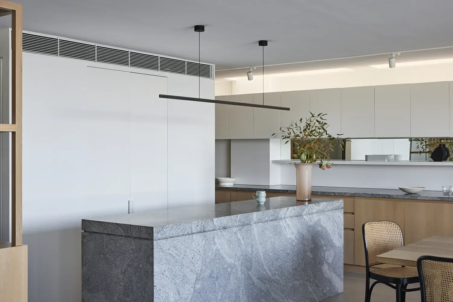 A kitchen with a large island and a table and chairs