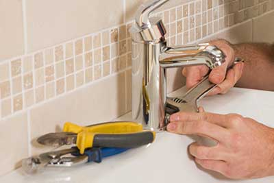 plumber installing faucet