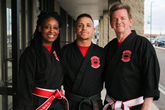 A man and two women are posing for a picture together