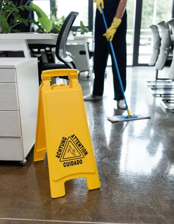Cleaner using floor buffer during commercial cleaning in Bridgeport lobby.