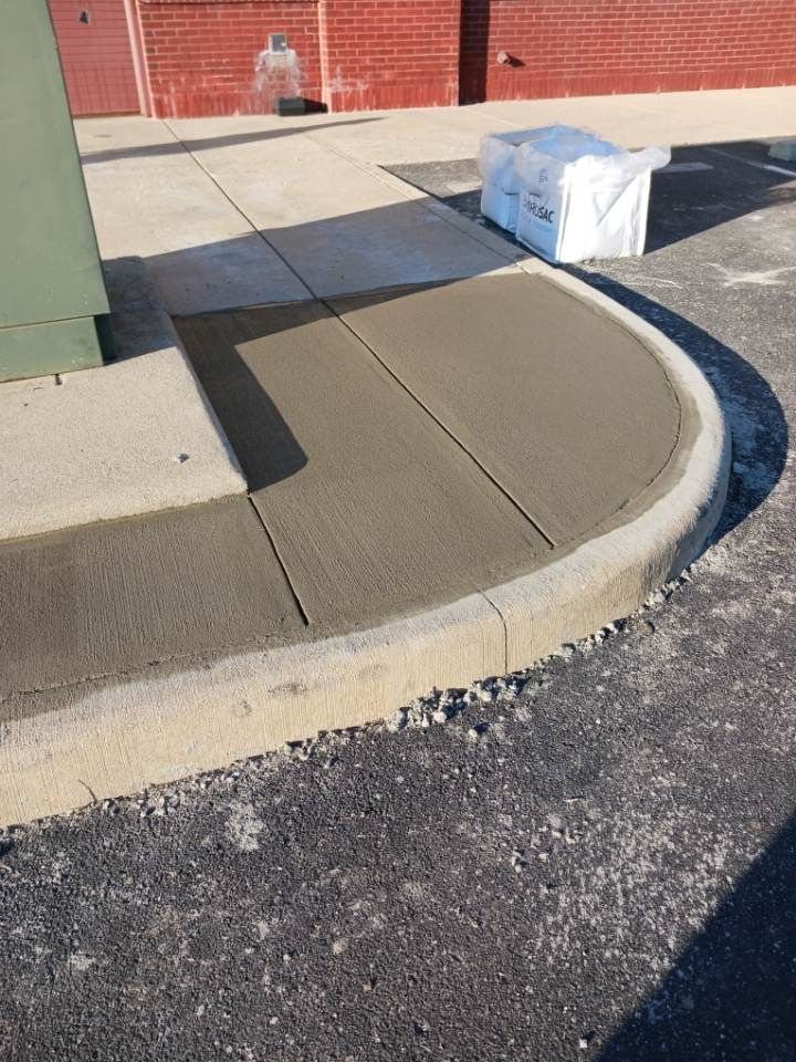 A sidewalk is being built on the side of a road.