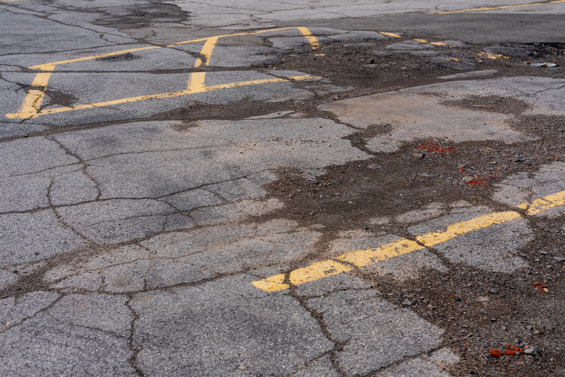 Parking lot on asphalt with yellow marked parking lines and old cracked pavement. Parking lot on asphalt with yellow marked parking lines and old cracked pavement.