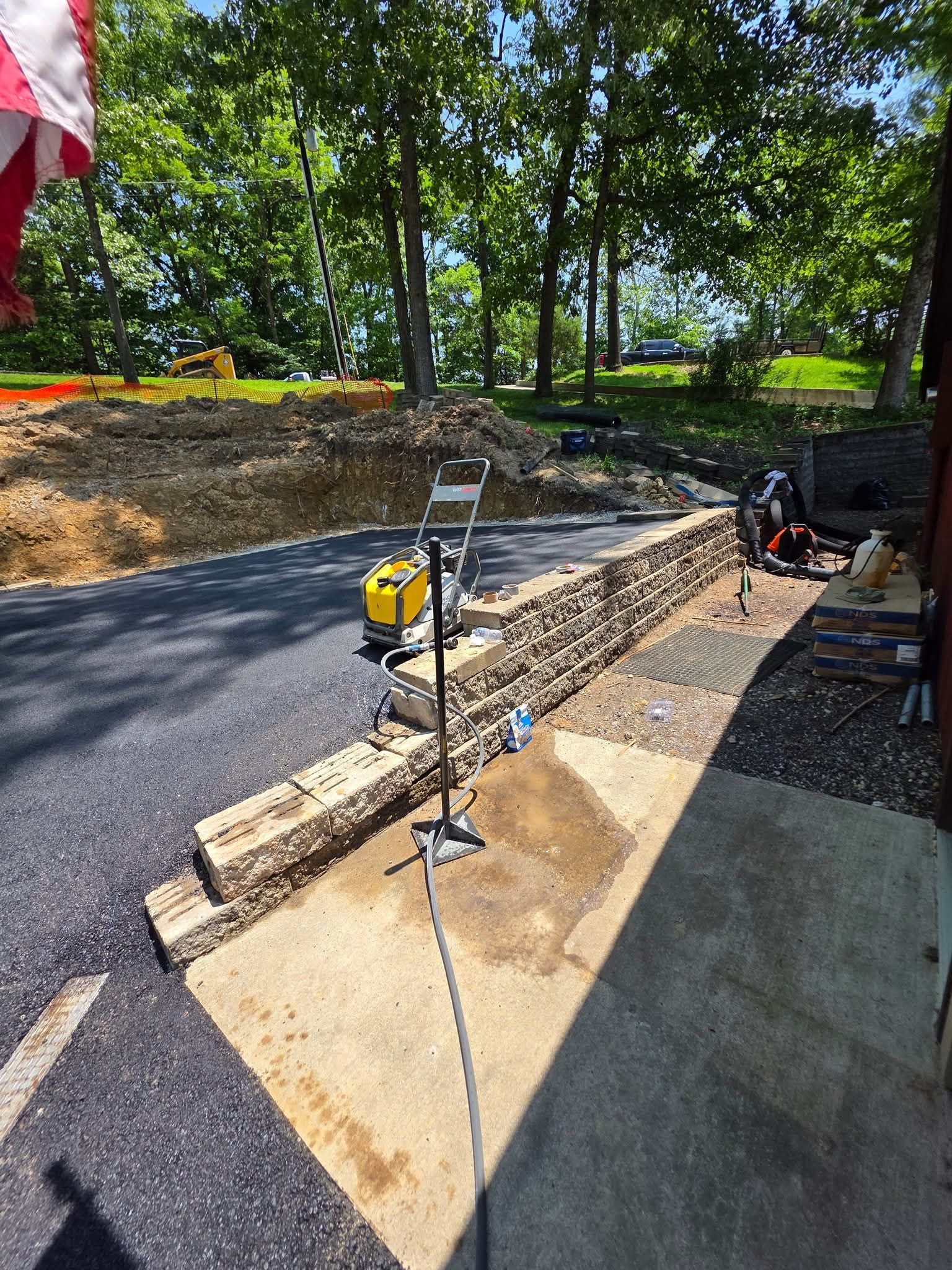 A brick wall is being built next to a road.