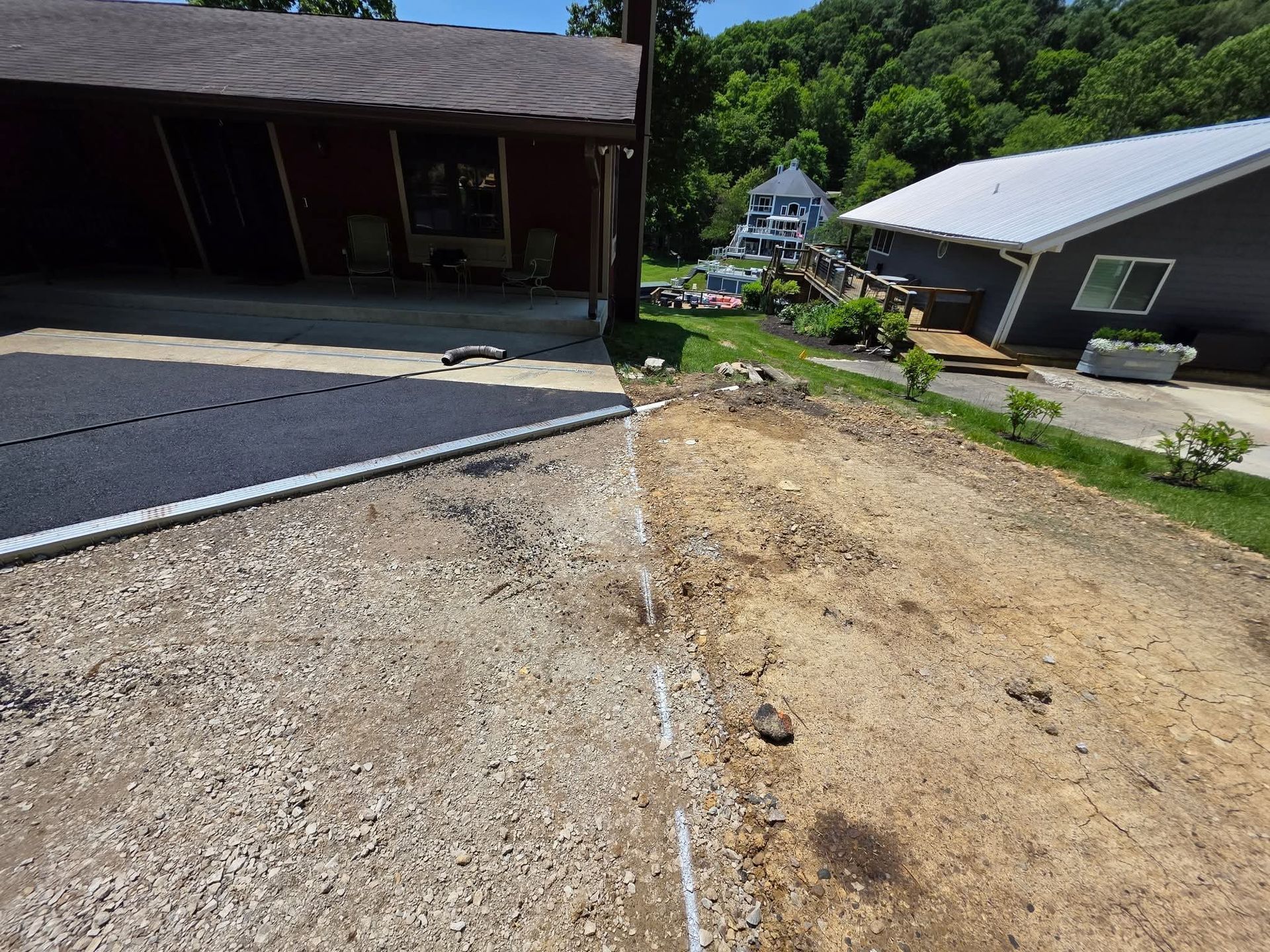 A house is being built next to a dirt road.