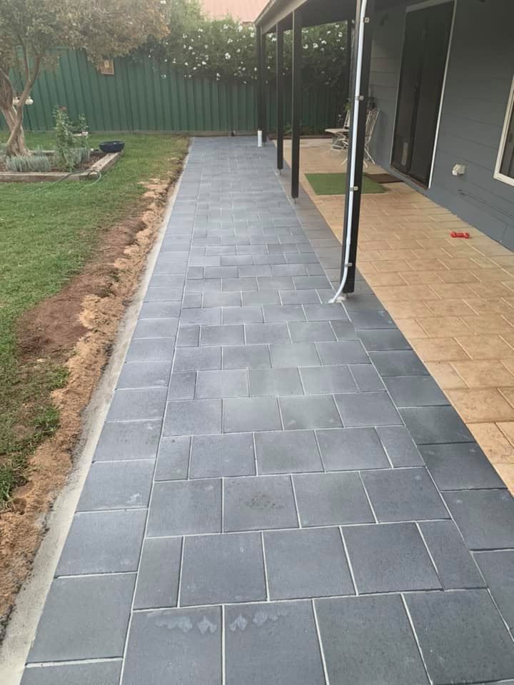 A Brick Walkway Leading to A House with A Covered Porch — Creative Spaces Landscaping in Dubbo, NSW