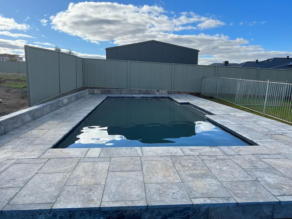 A Large Swimming Pool Surrounded by A Fence — Creative Spaces Landscaping in Dubbo, NSW