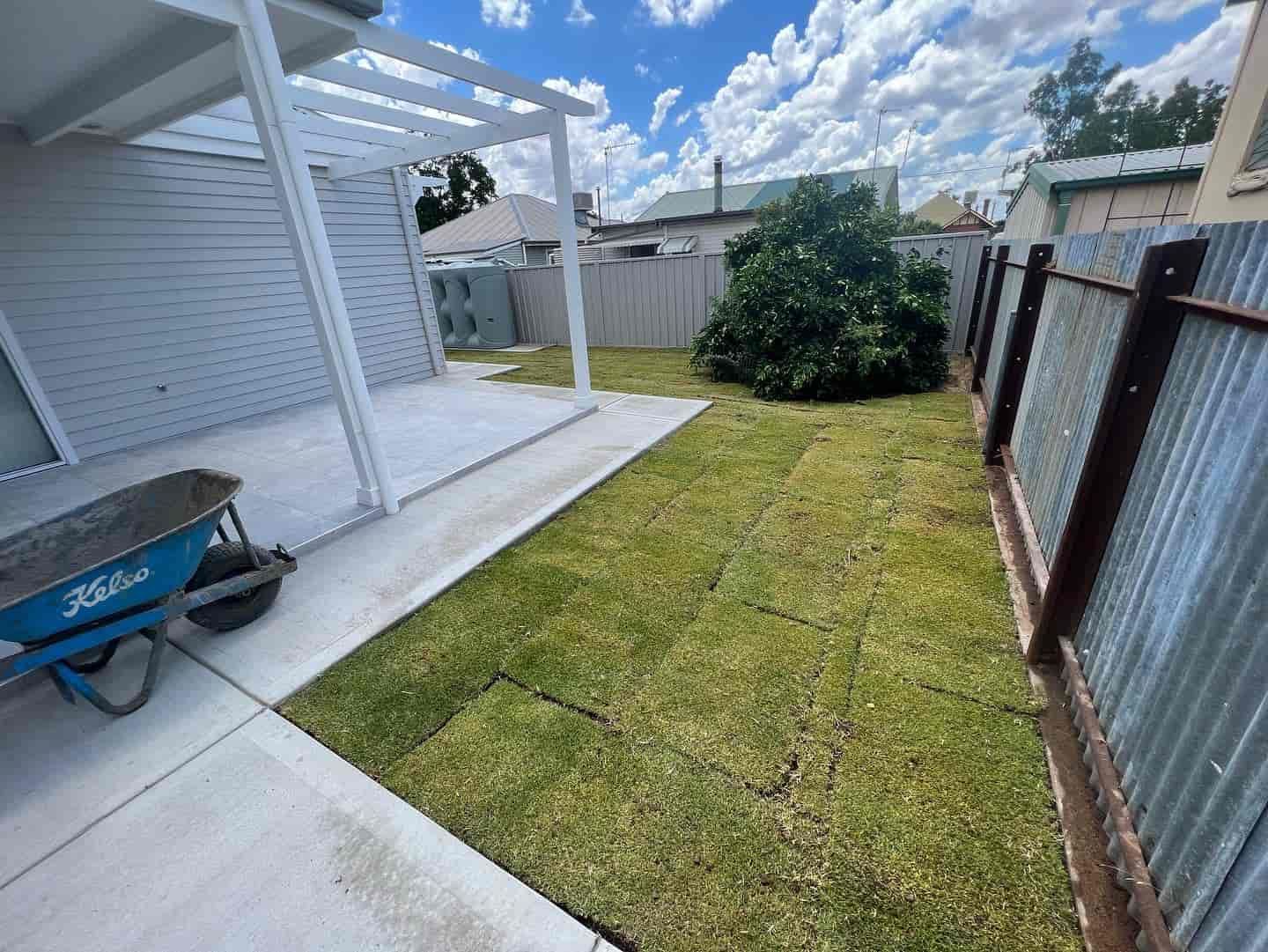 A Wheelbarrow Int the Backyard of A House — Creative Spaces Landscaping in Dubbo, NSW