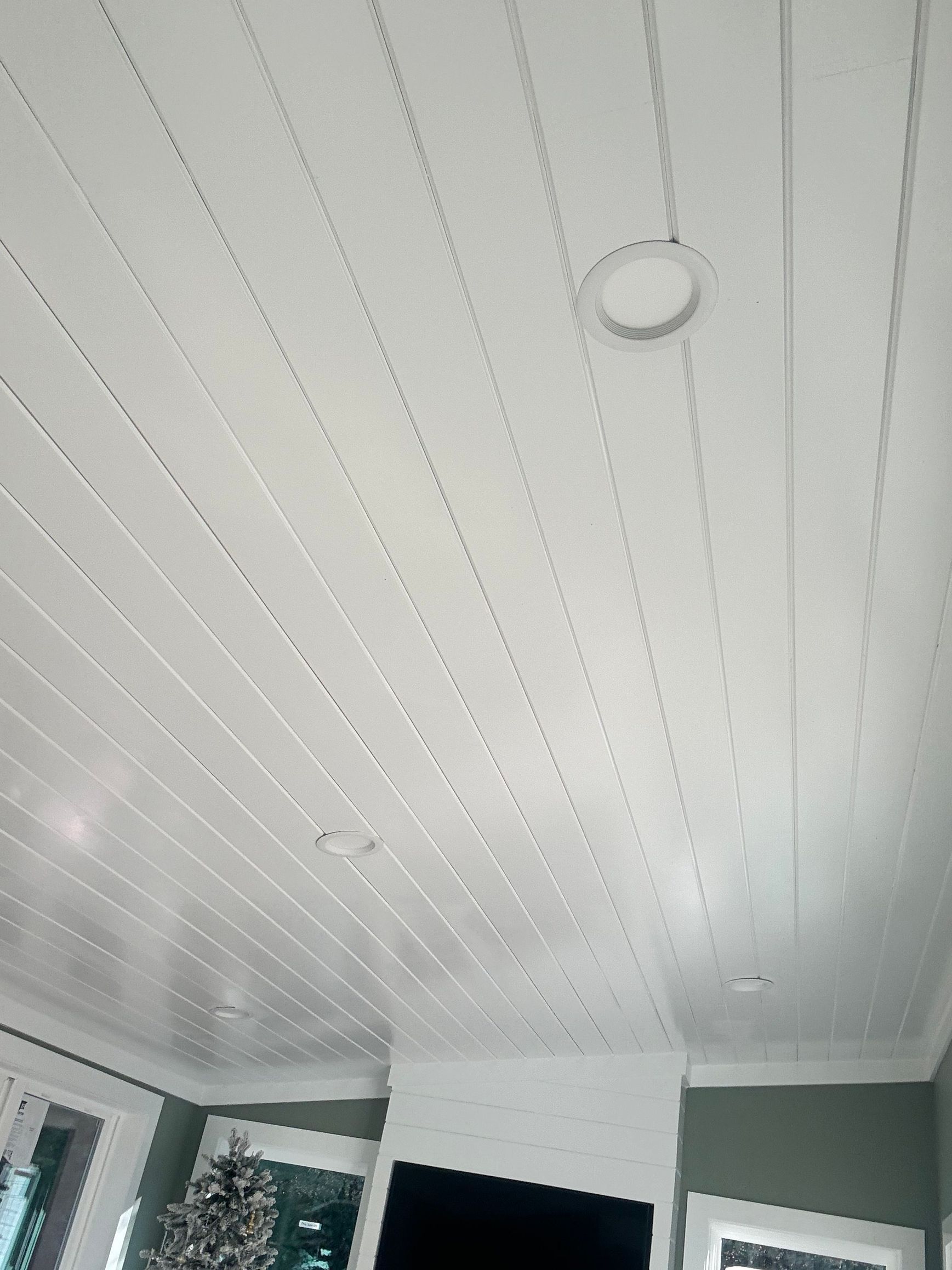 White planked ceiling with recessed lighting.
