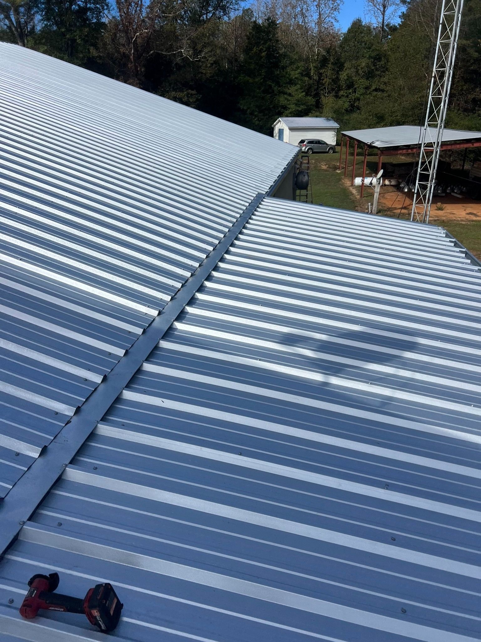 A close up of a metal roof with a chain hanging from it.
