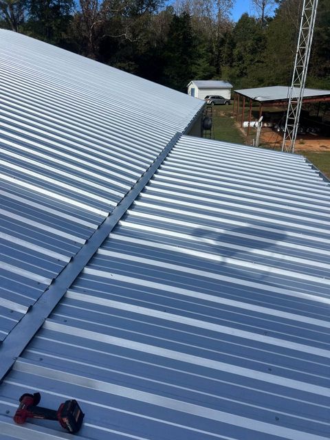 A close up of a metal roof with a chain hanging from it.