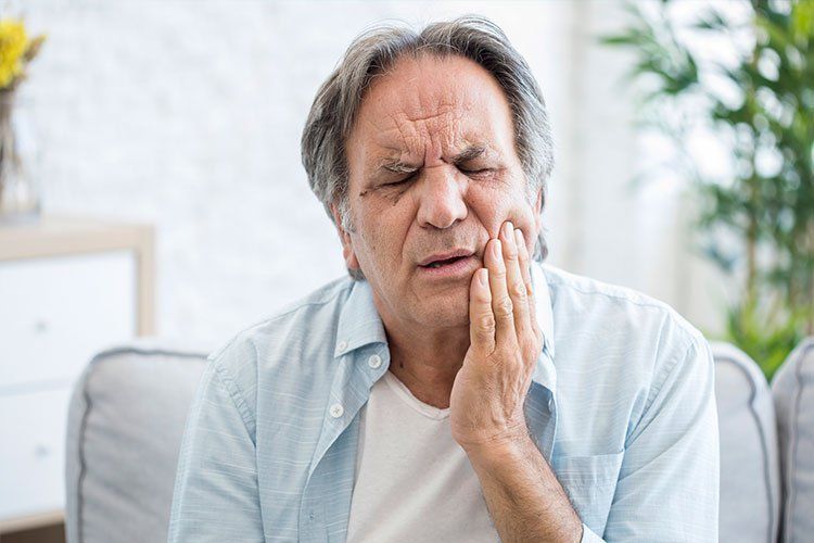 elder man with tooth pain