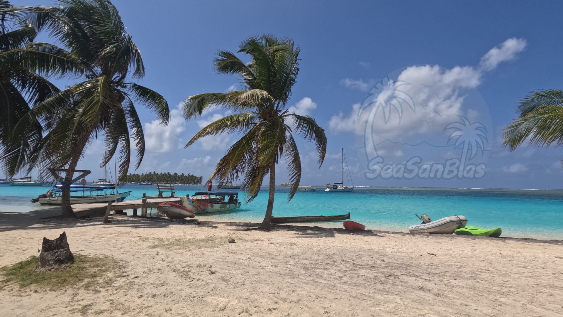 a group of people are sitting on a boat in san blas smiling going to yanis island